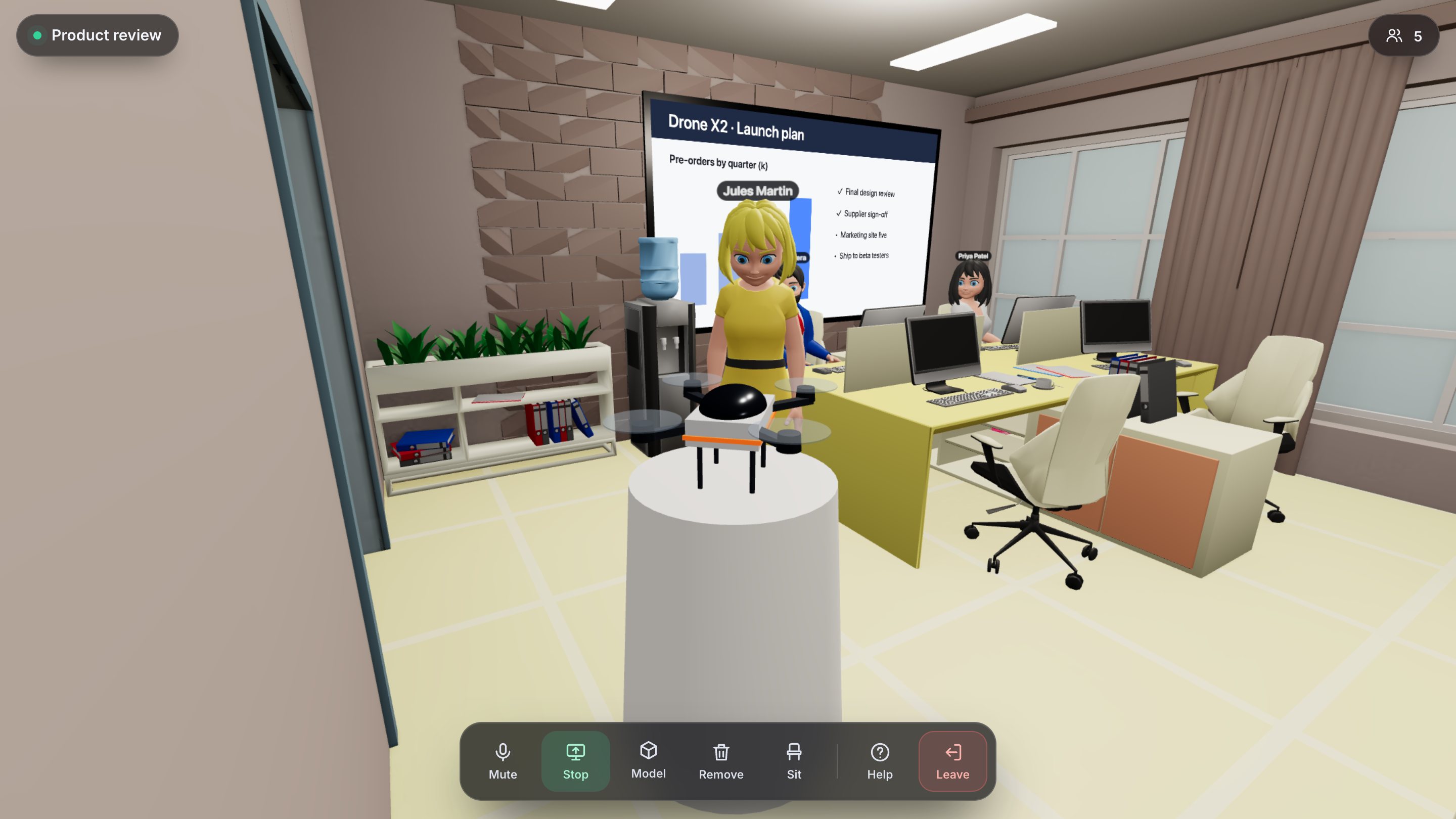 A teammate standing next to a drone prototype on a stand in the meeting room.